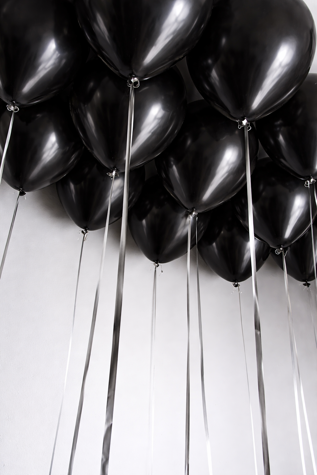 All black helium ceiling balloons with ribbons in New York City