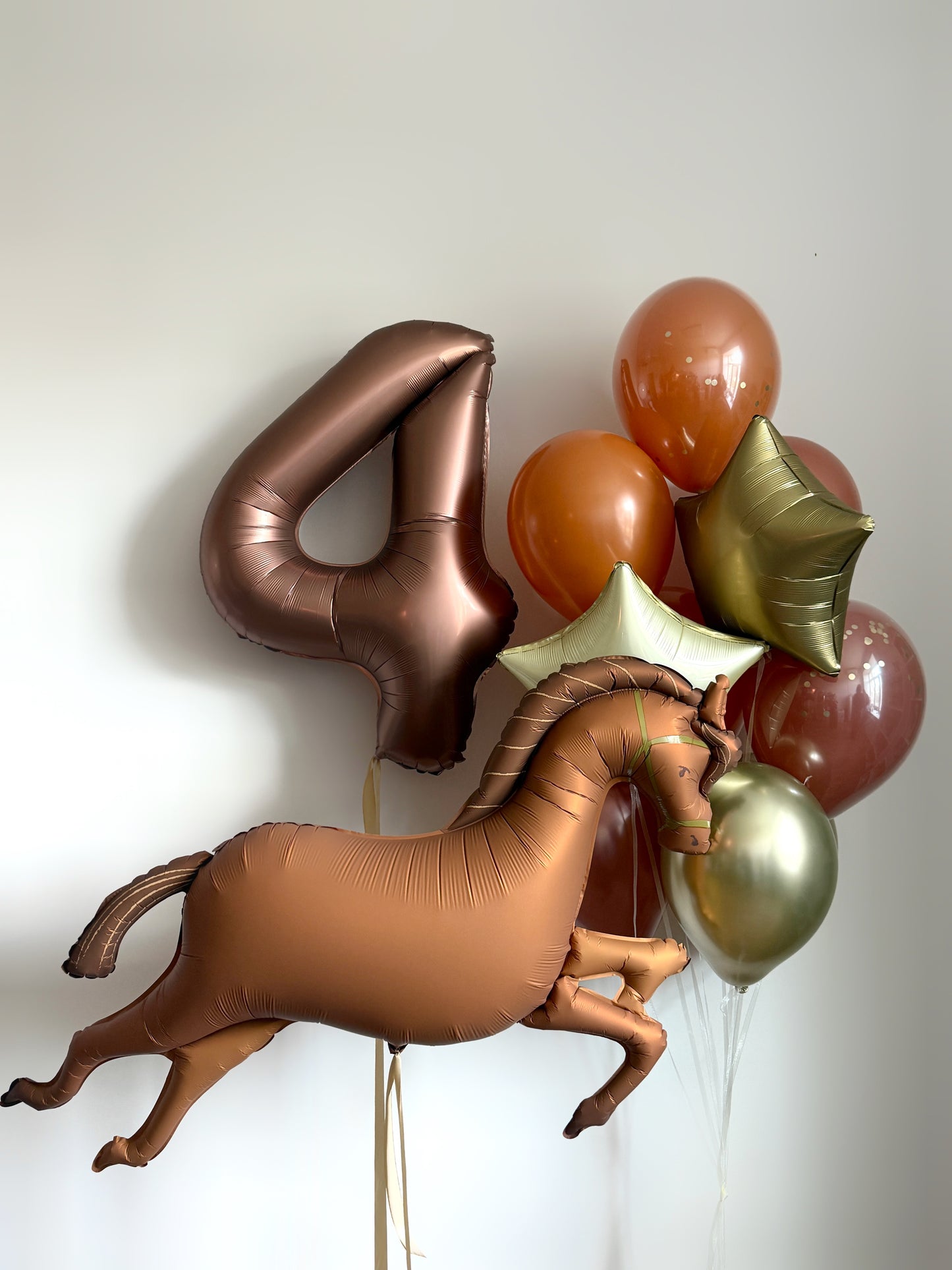 Bronze horse balloon set with number balloon, star balloons, and matching latex balloons for birthday decor in NYC