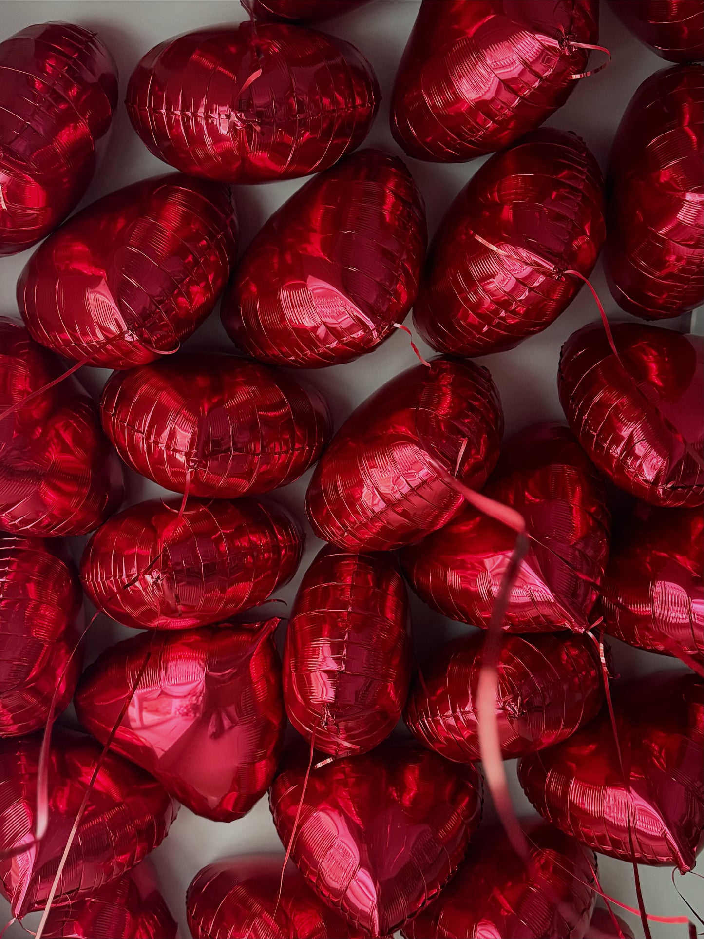 Red heart-shaped helium balloons arranged together, luxury balloon delivery in New York City