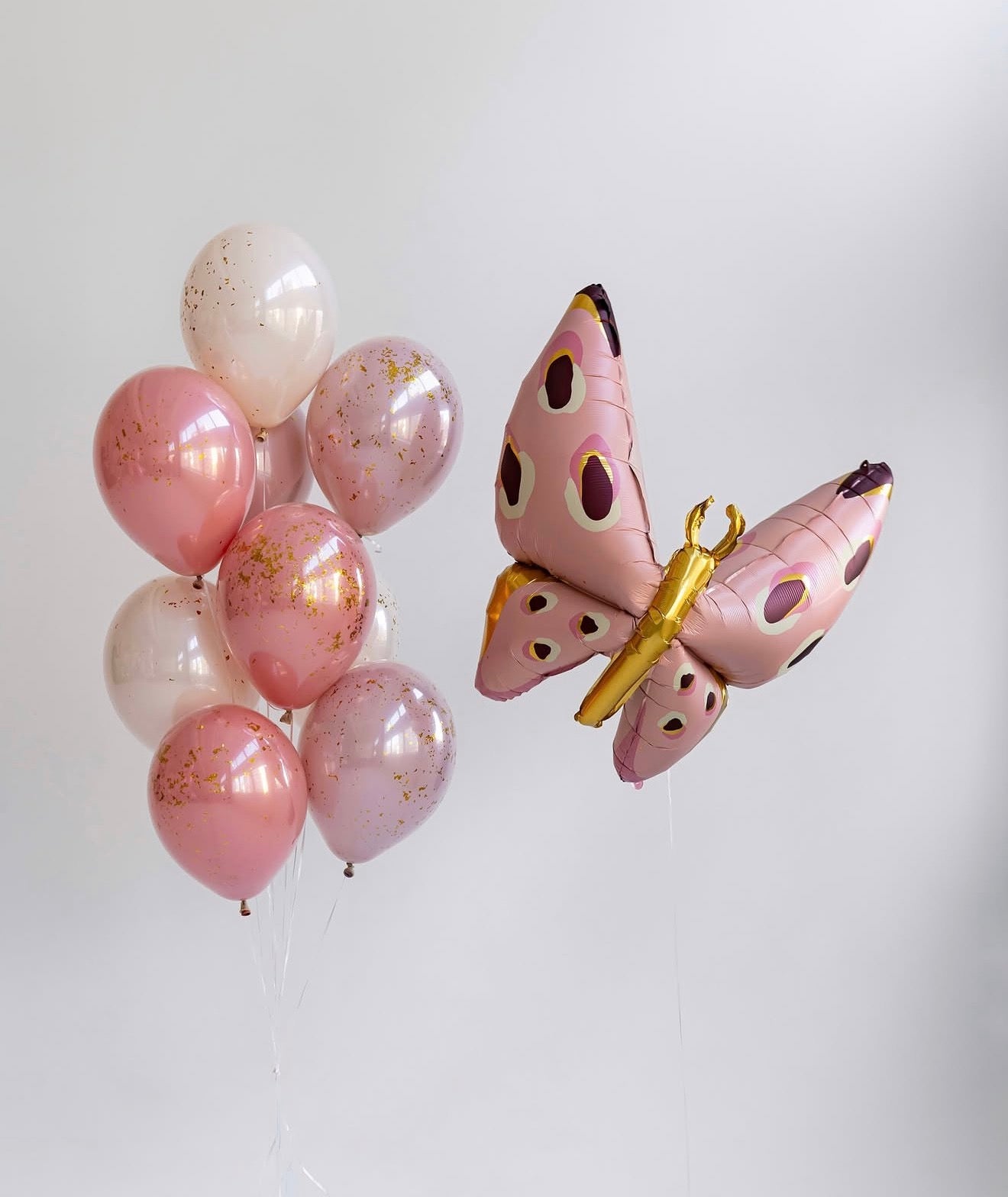Butterfly Kiss balloon set with pink double stuffed balloons, gold flakes, and butterfly balloon for celebration decor in Staten Island