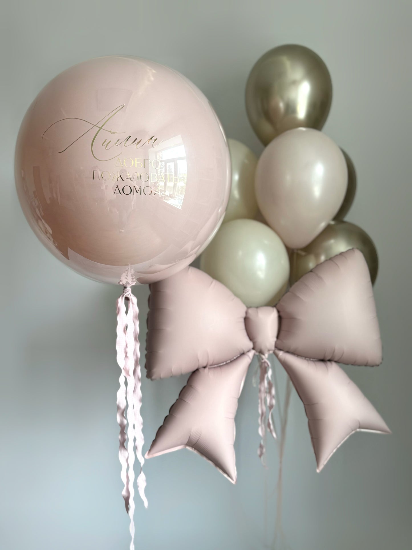Dusty rose celebration balloon set with custom sign bubble balloon and oversized bow for elegant decor in New York