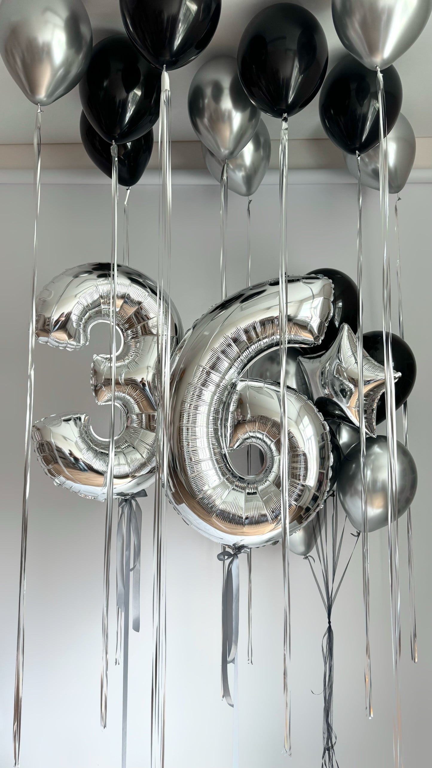Classic birthday balloon set with silver number balloons and black white balloon decor in New York
