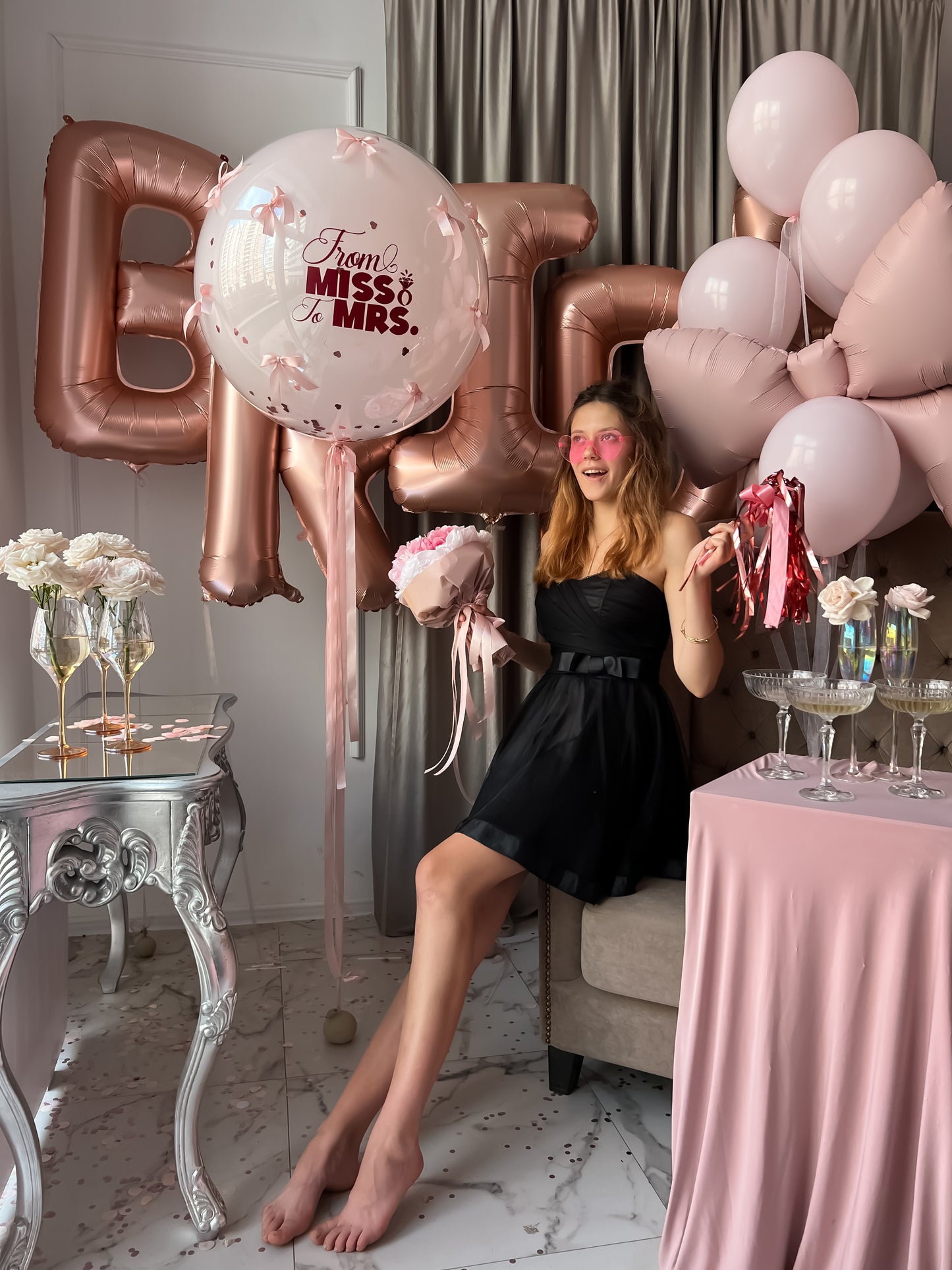 Pink bachelorette balloon setup with bow balloon and BRIDE letters for party decor in Manhattan