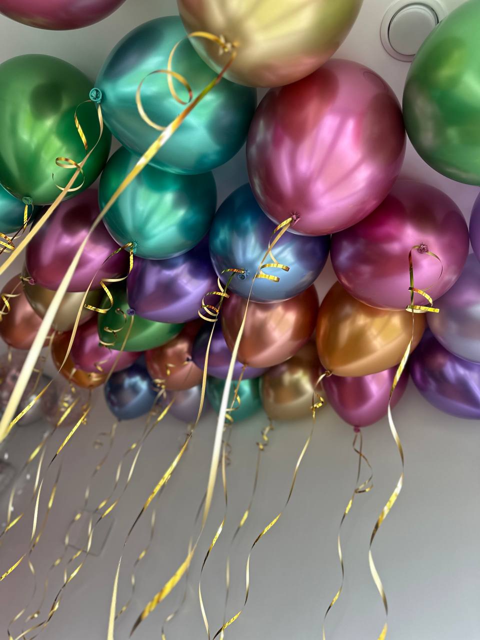 Metallic reflex helium ceiling balloons with ribbons in New York City
