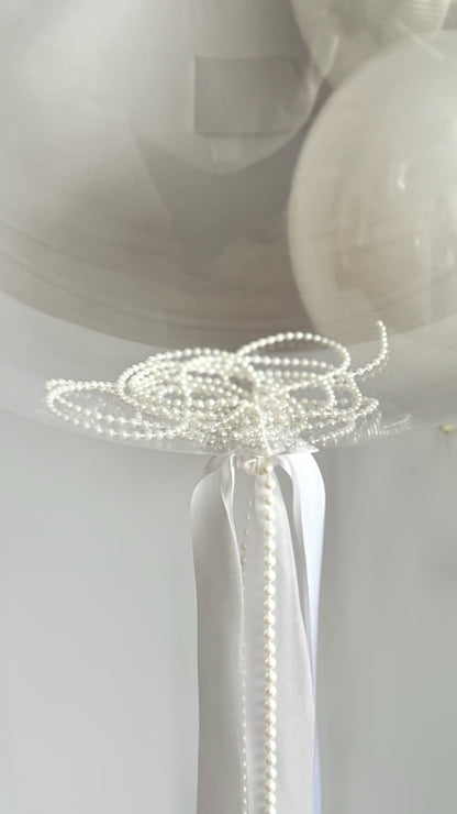 Close-up of clear bubble balloon knot and ribbon styling for bridal event decor in NYC