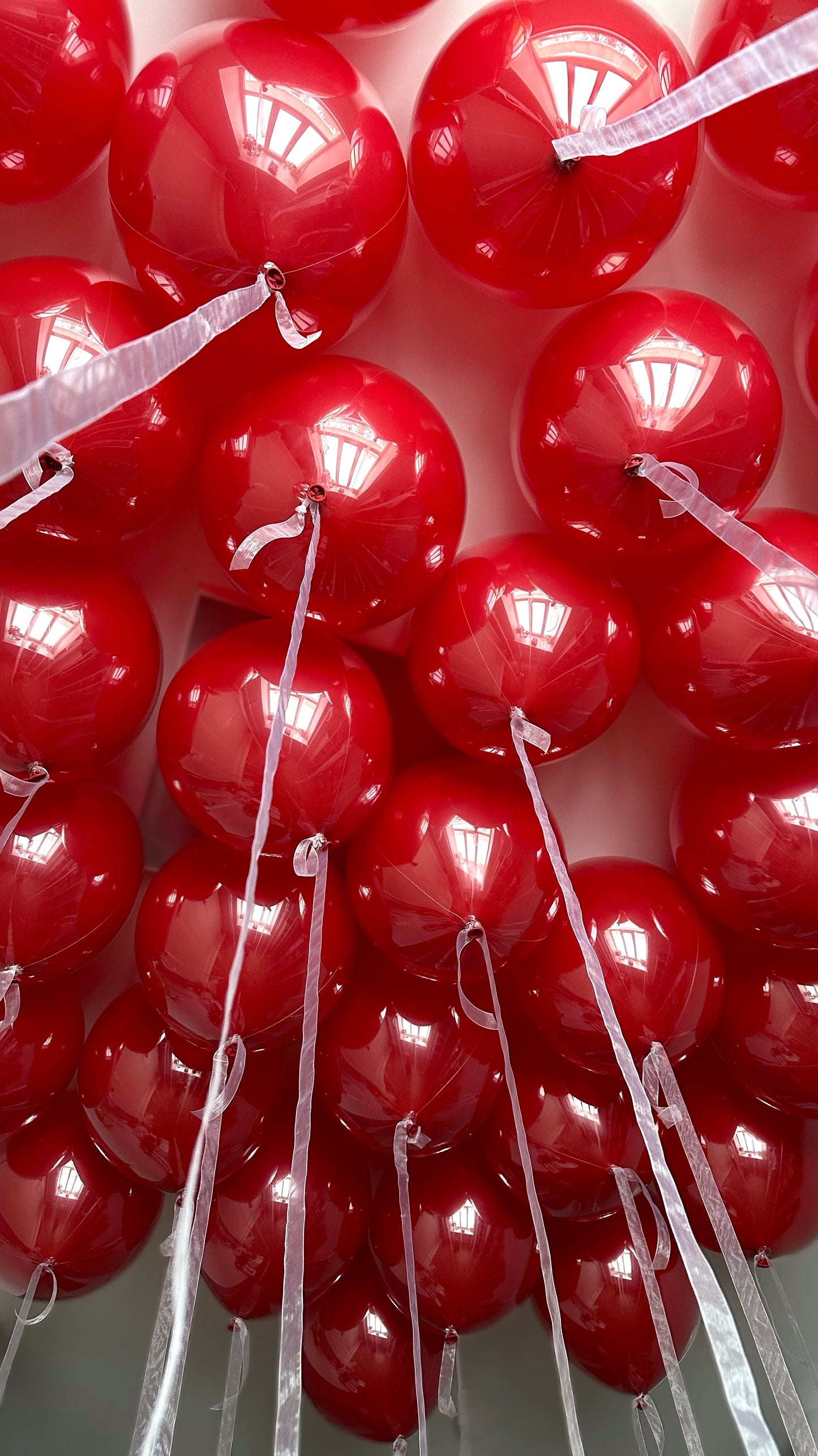 Red bubble balloon installation arranged in a dense statement display for event decor in New York