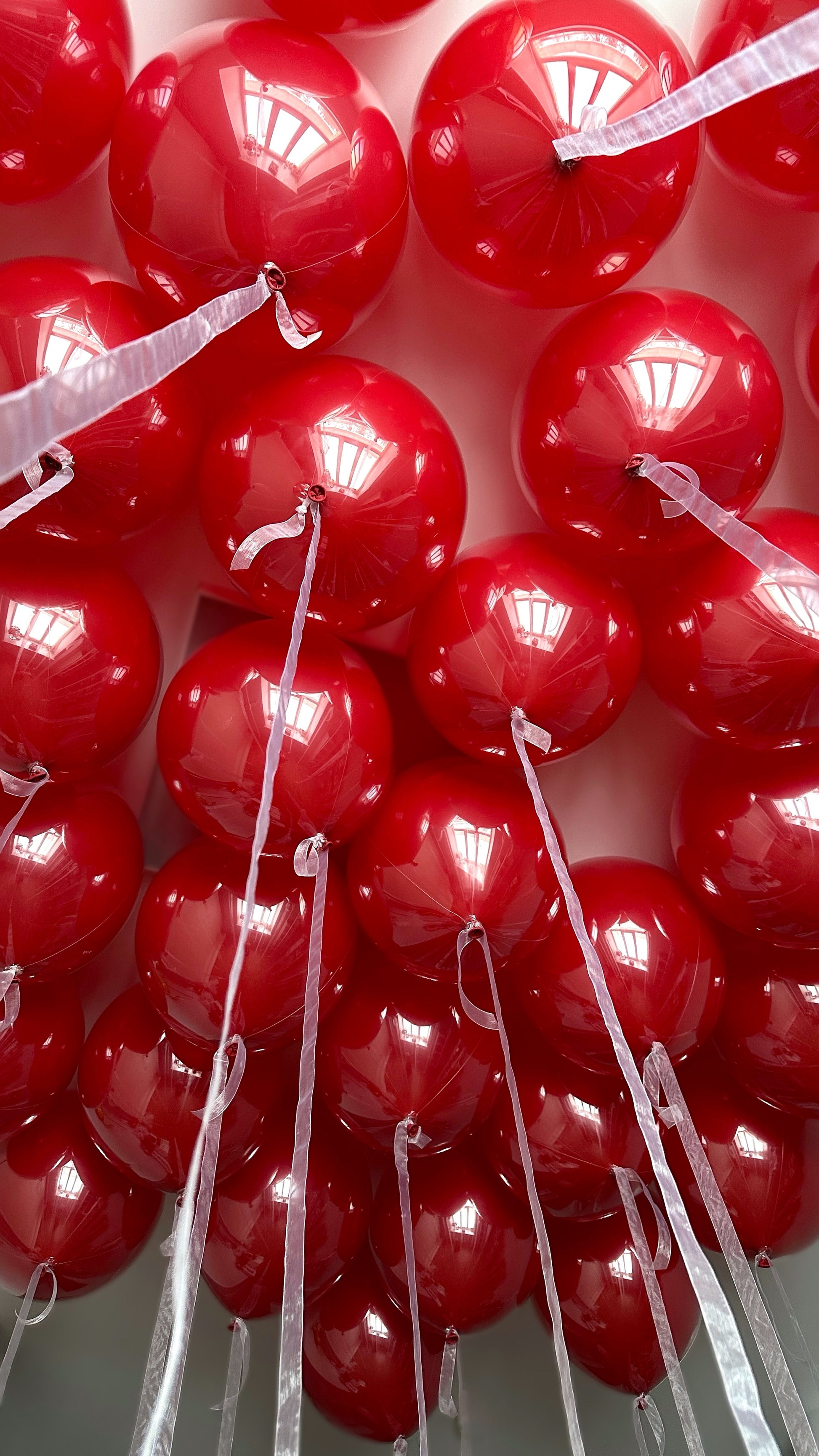 Red bubble balloon installation arranged in a dense statement display for event decor in New York