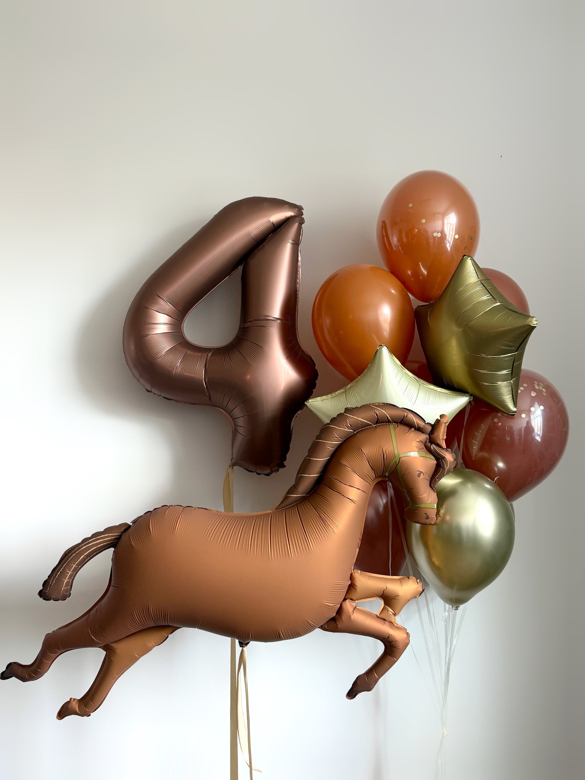 Bronze horse balloon set with number balloon, star balloons, and matching latex balloons for birthday decor in NYC