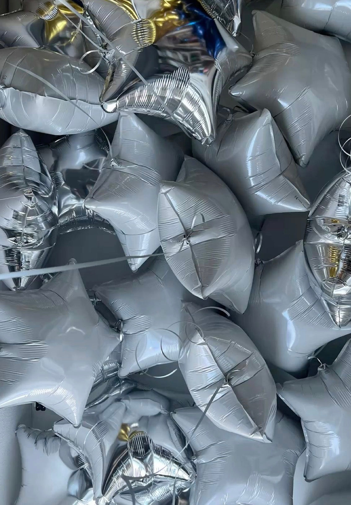 Metallic star-shaped helium ceiling balloons in New York City
