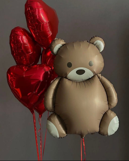 Teddy bear balloon with floating red heart balloons for romantic surprise decor in Brooklyn