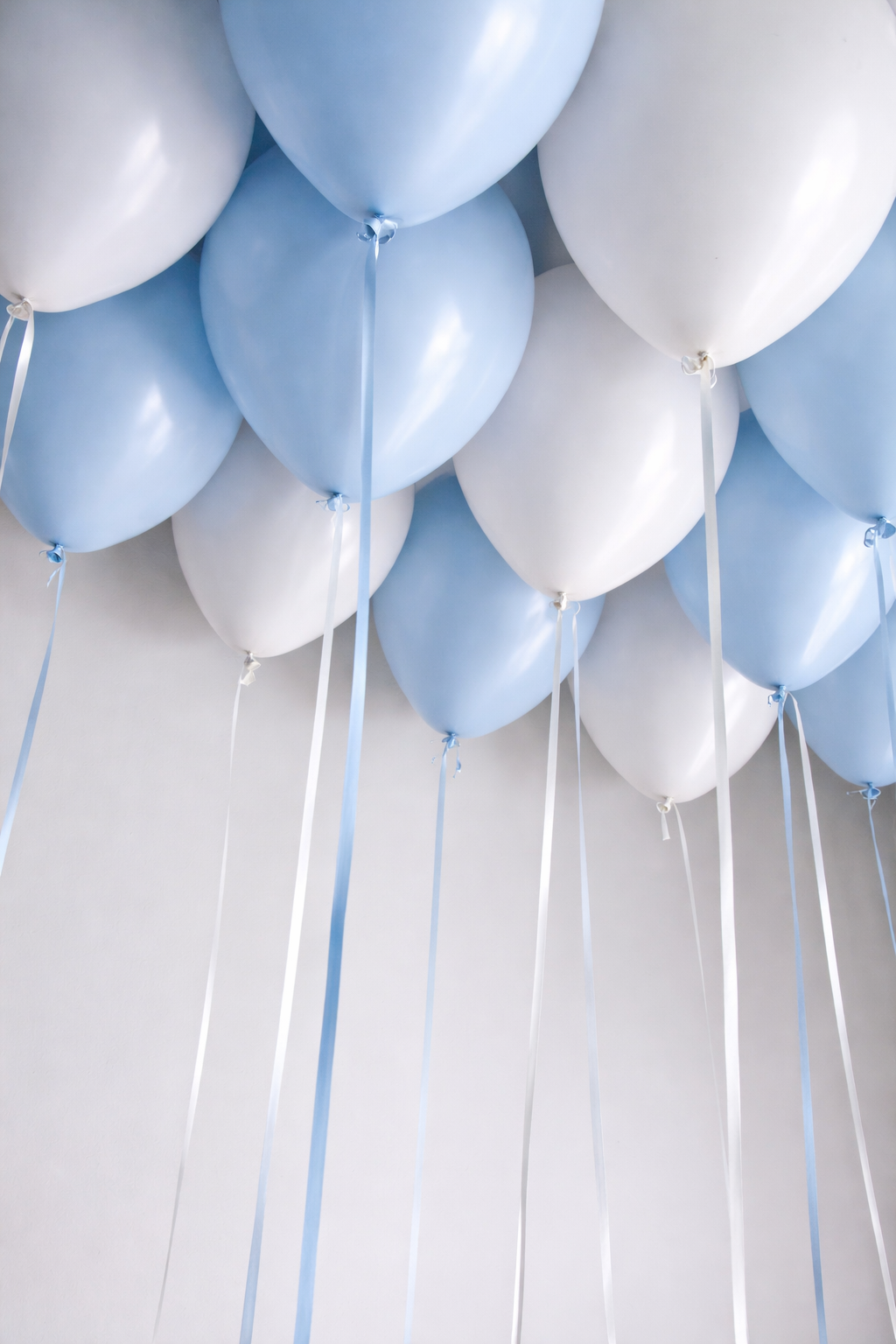 White and pastel blue helium ceiling balloons with ribbons in New York City
