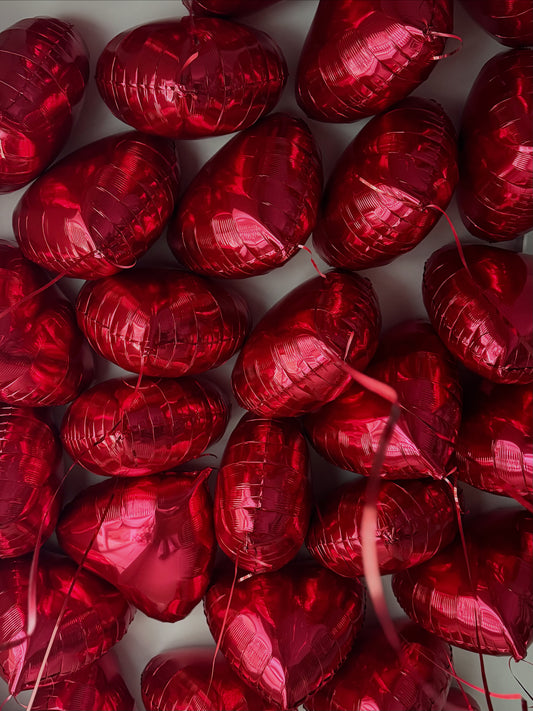 Red heart-shaped helium balloons arranged together, luxury balloon delivery in New York City