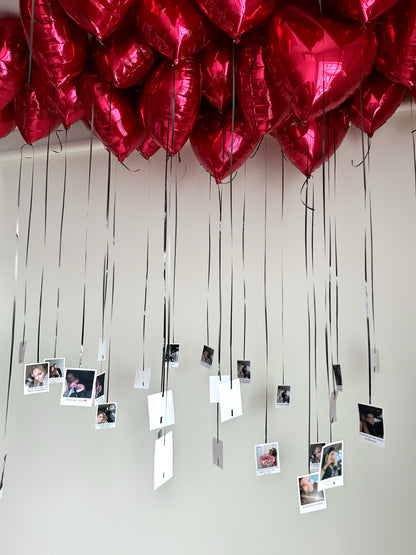 Heart-shaped helium balloons with hanging photo prints for romantic decor in New York