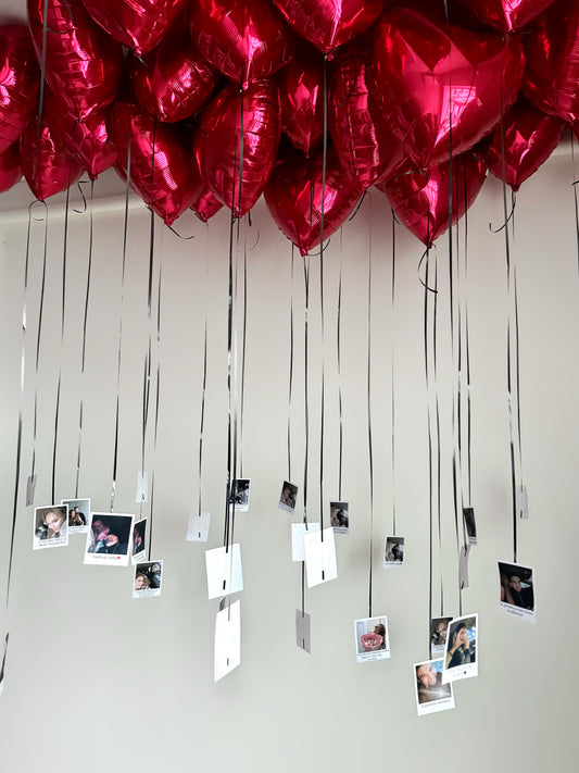 Heart-shaped helium balloons with hanging photo prints for romantic decor in New York
