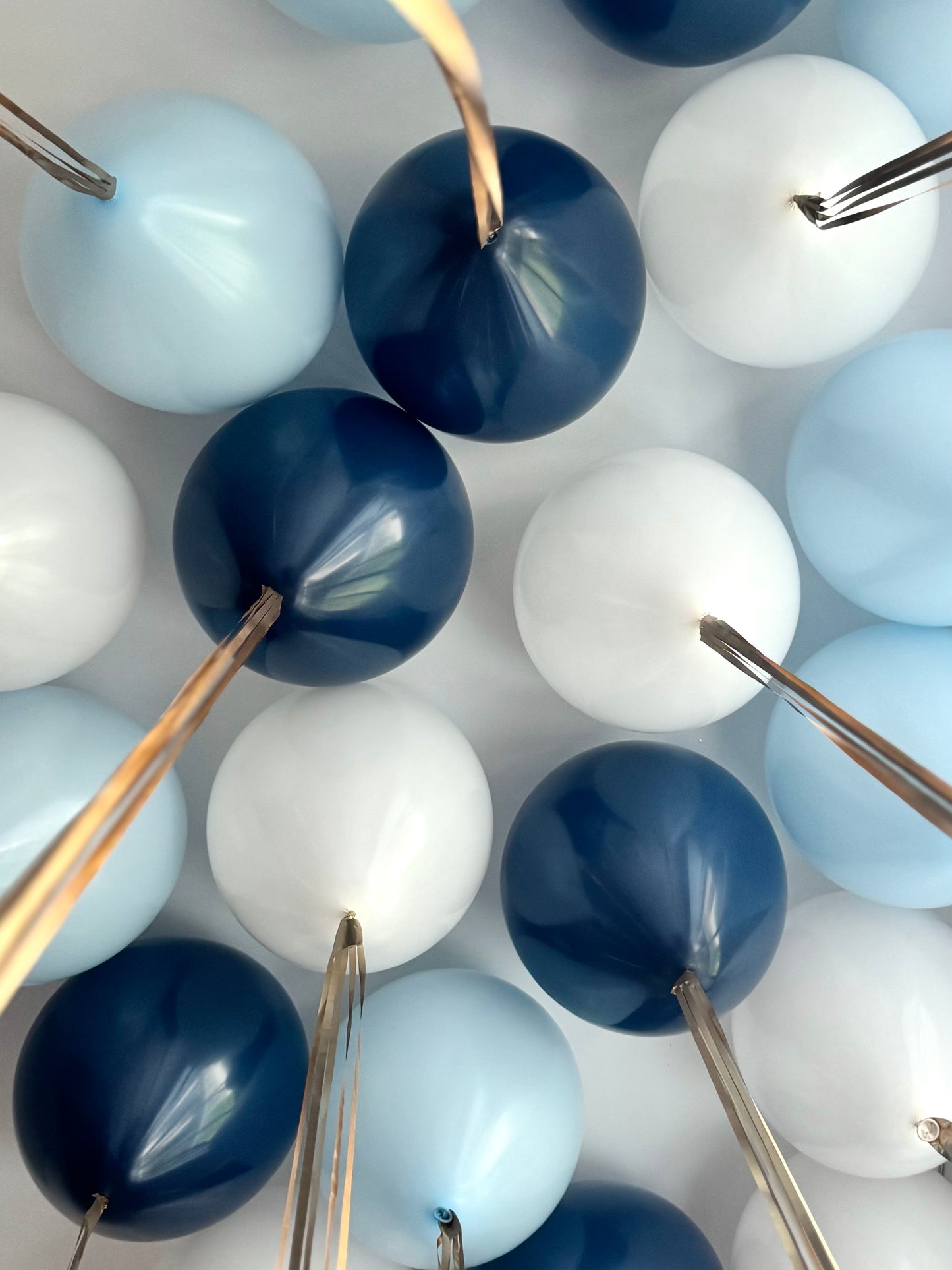 White pastel blue and blue helium ceiling balloons with ribbons in New York City
