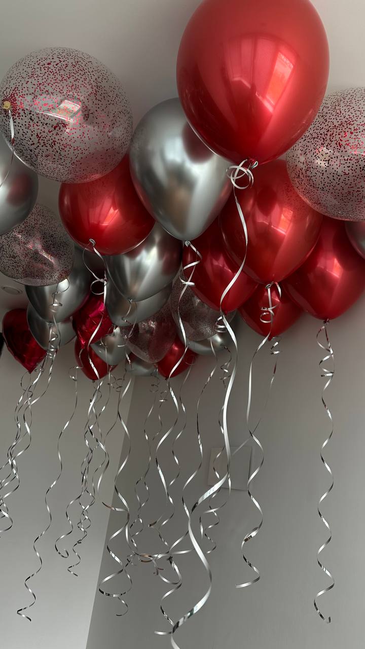 Red and silver helium ceiling balloons with ribbons in New York City

