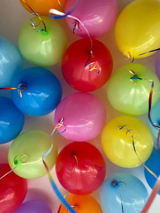 Multicolor helium ceiling balloons with ribbons in New York City
