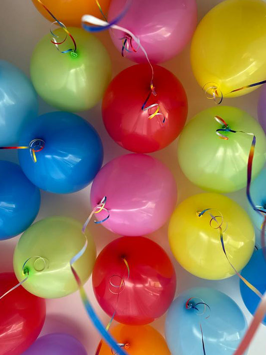 Multicolor helium ceiling balloons with ribbons in New York City

