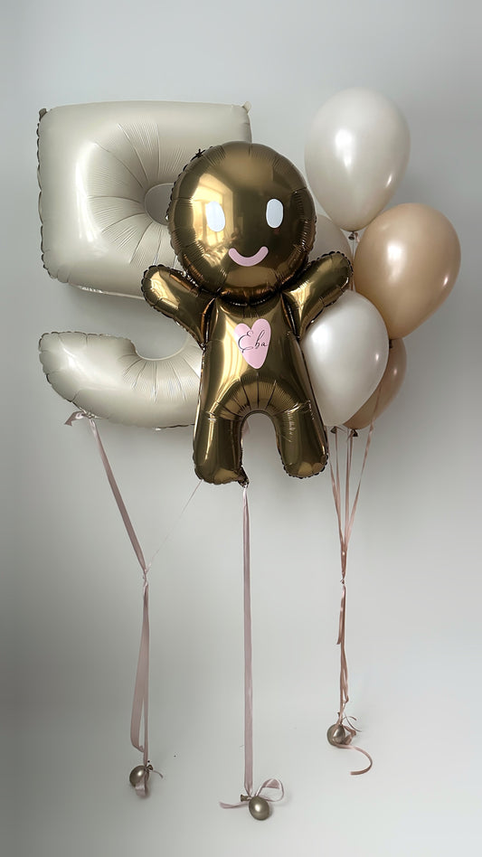 Baby gingerbread balloon set with gingerbread balloon, number balloon, and neutral birthday decor in New York