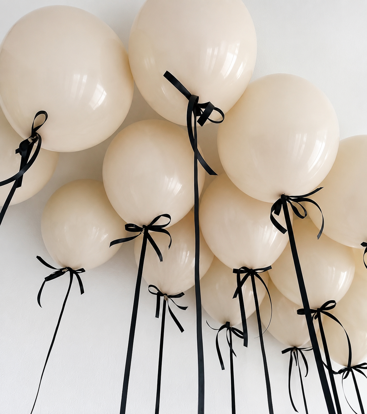 Beige with Black Bow Ceiling Balloons featuring soft beige helium balloons with long black ribbons and elegant black bow details in Brooklyn