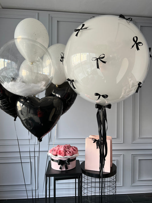 Black tie balloon set with bow balloon, feather bubble balloon, and black heart balloons for elegant celebration decor in New York