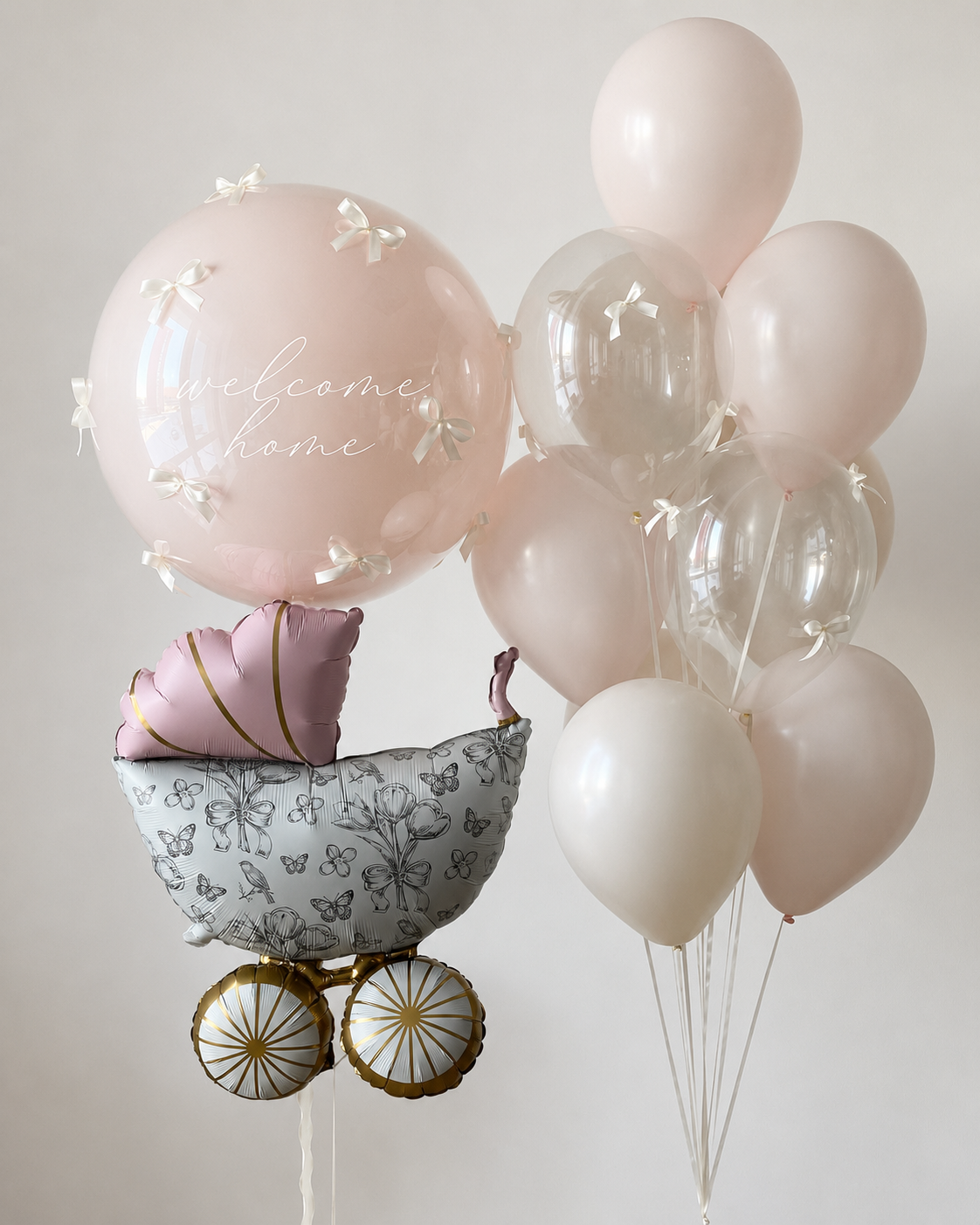Blush welcome home baby balloon set with custom bubble balloon, stroller foil balloon and 10 latex balloons in Brooklyn