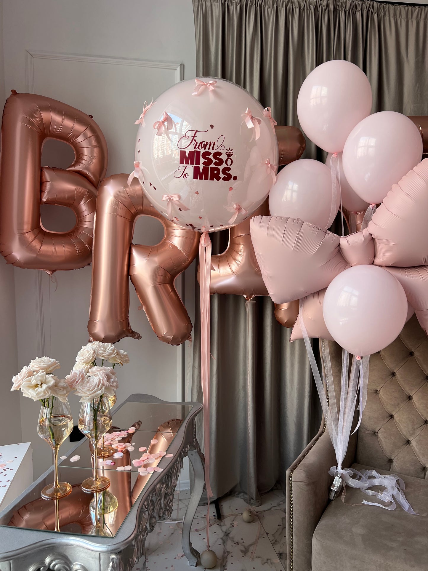 Close-up of bridal balloon decor with BRIDE letters and custom bubble balloon for bachelorette party in Brooklyn