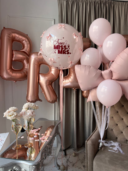 Close-up of bridal balloon decor with BRIDE letters and custom bubble balloon for bachelorette party in Brooklyn