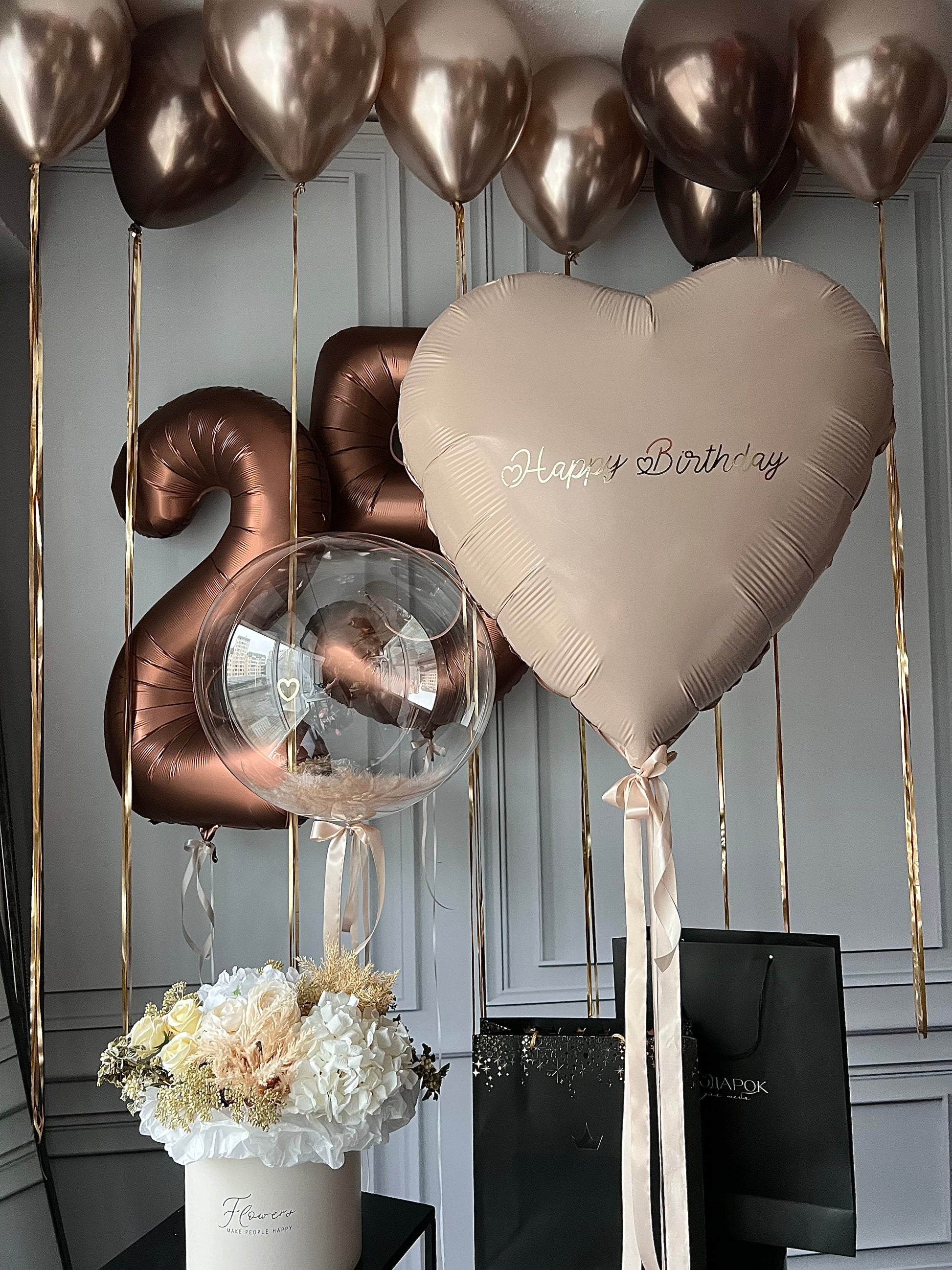 Bronze birthday balloon set with number balloons, heart balloon with sign, and feather bubble balloon in New York