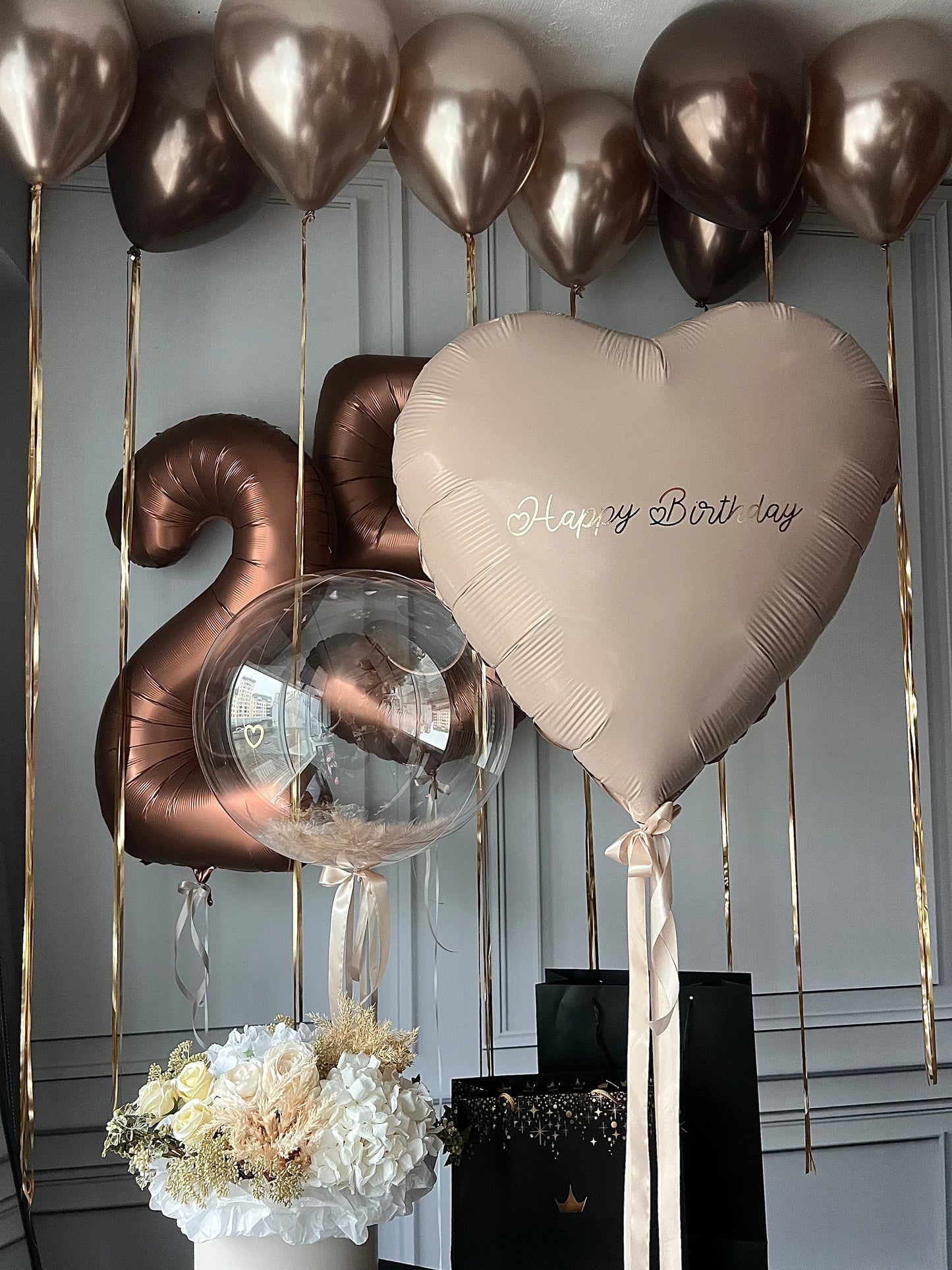 Close-up of bronze birthday balloons with custom heart balloon and number balloons in Brooklyn