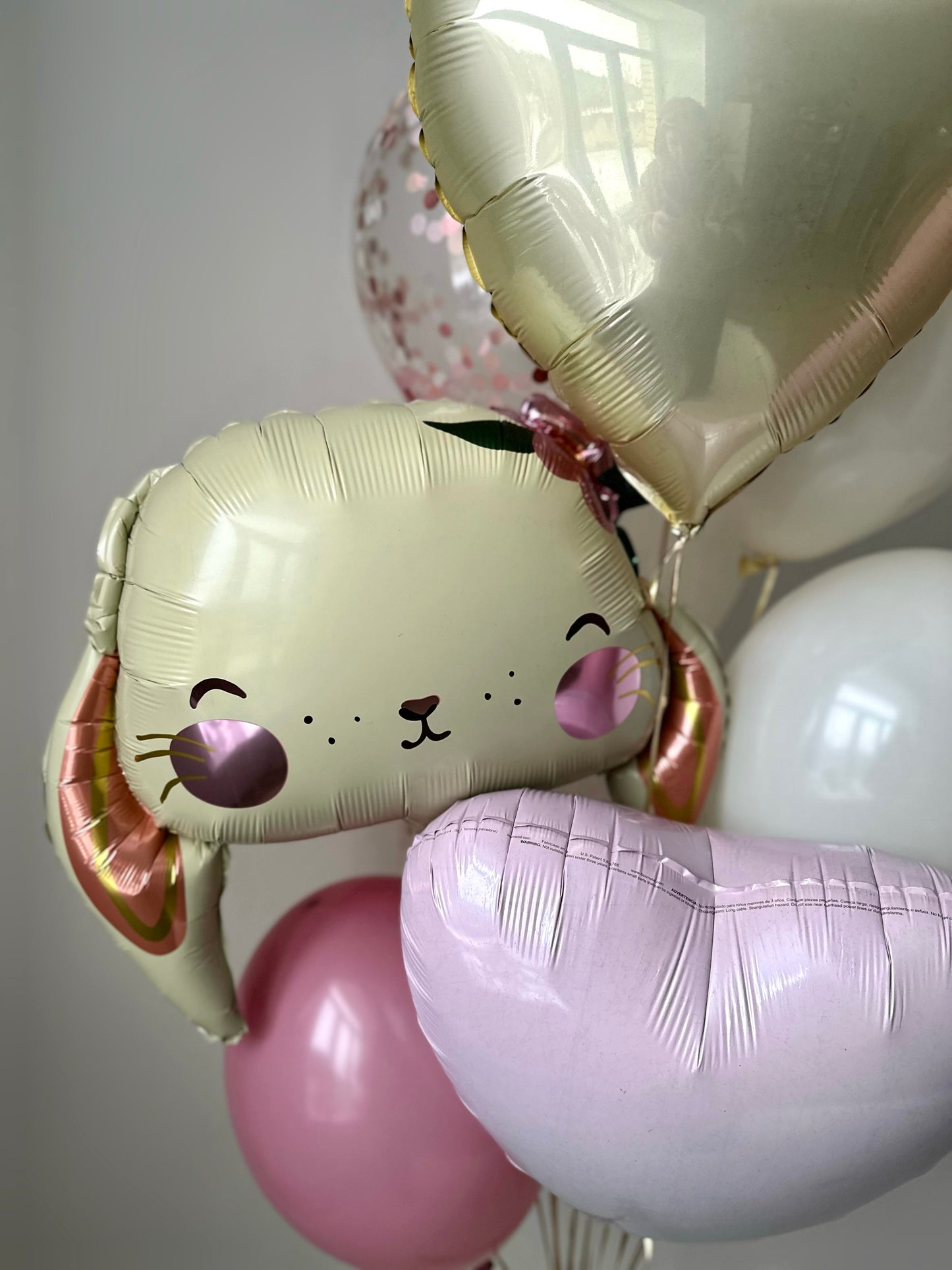 Close-up of bunny and pastel heart balloon decor for first birthday party in Brooklyn