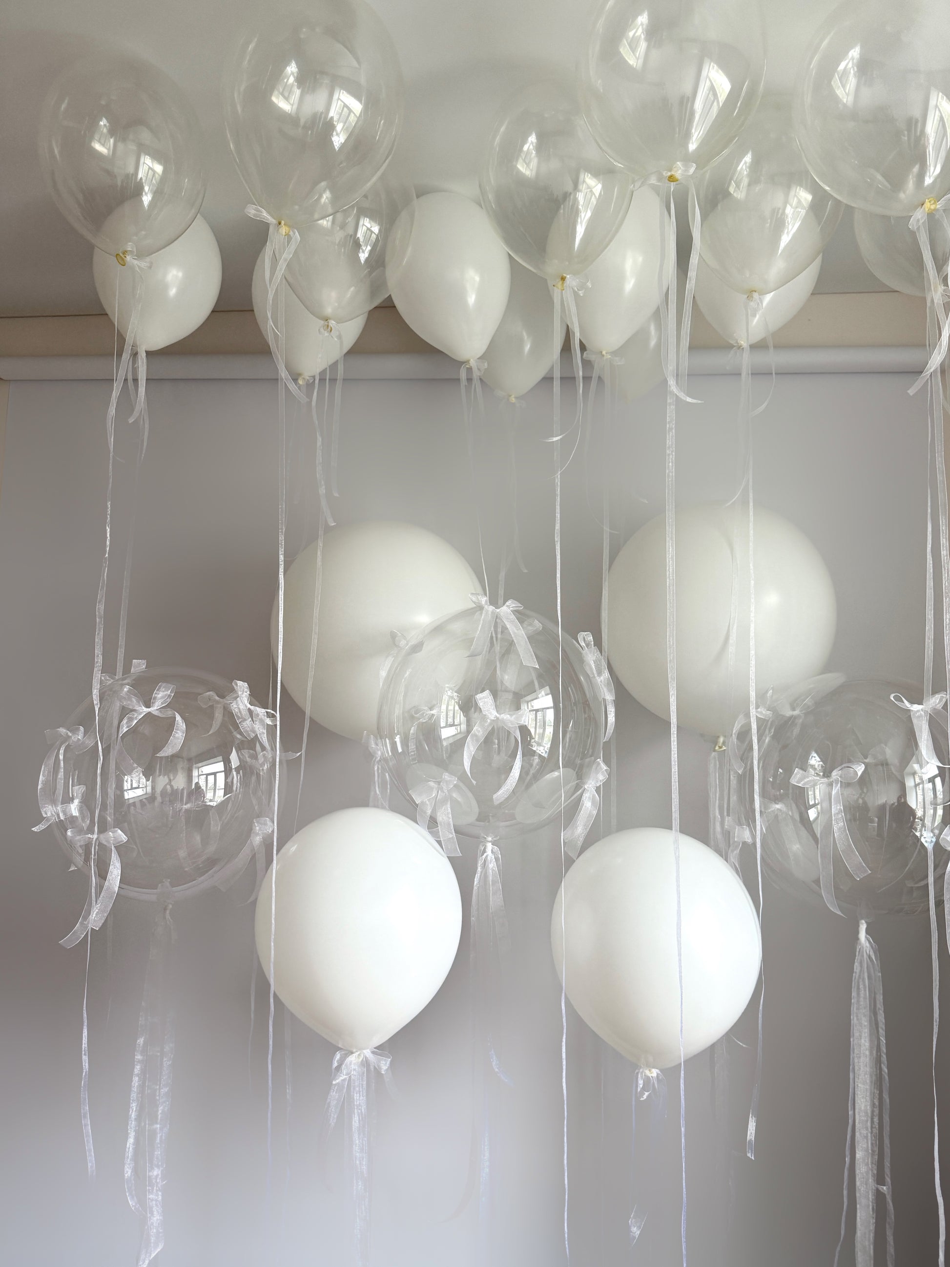 Clear mind balloon set with clear bubble balloons, organza bows, and elegant white balloon decor in New York