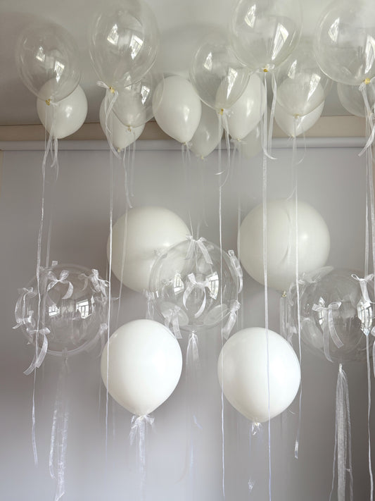 Clear mind balloon set with clear bubble balloons, organza bows, and elegant white balloon decor in New York