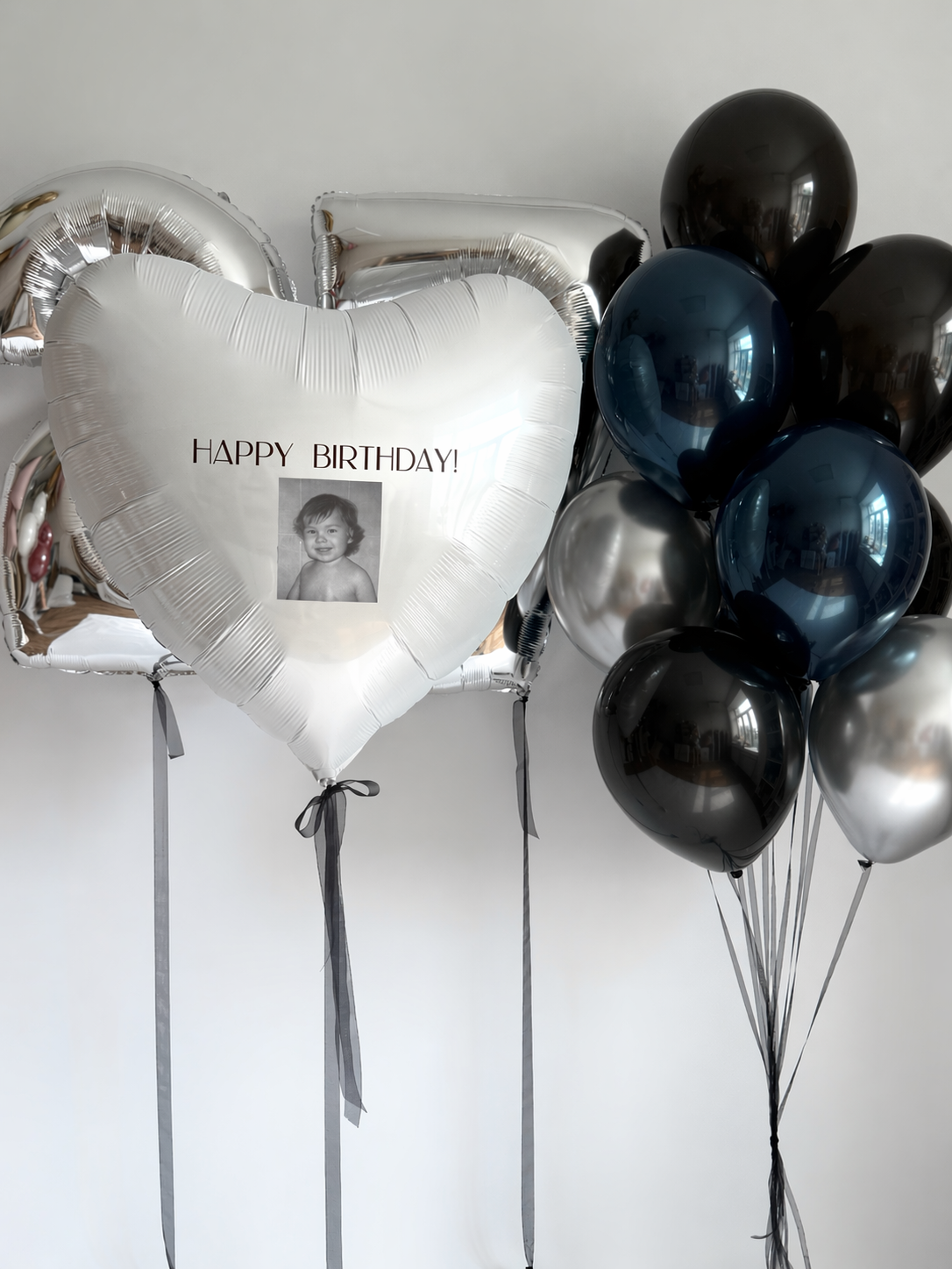 Deep ocean birthday balloon set with photo heart balloon, number balloons, and blue black silver decor in New York