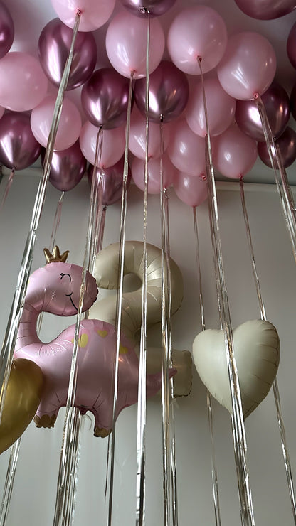 Dino princess birthday balloon decor with floating pink balloons and themed setup in Brooklyn