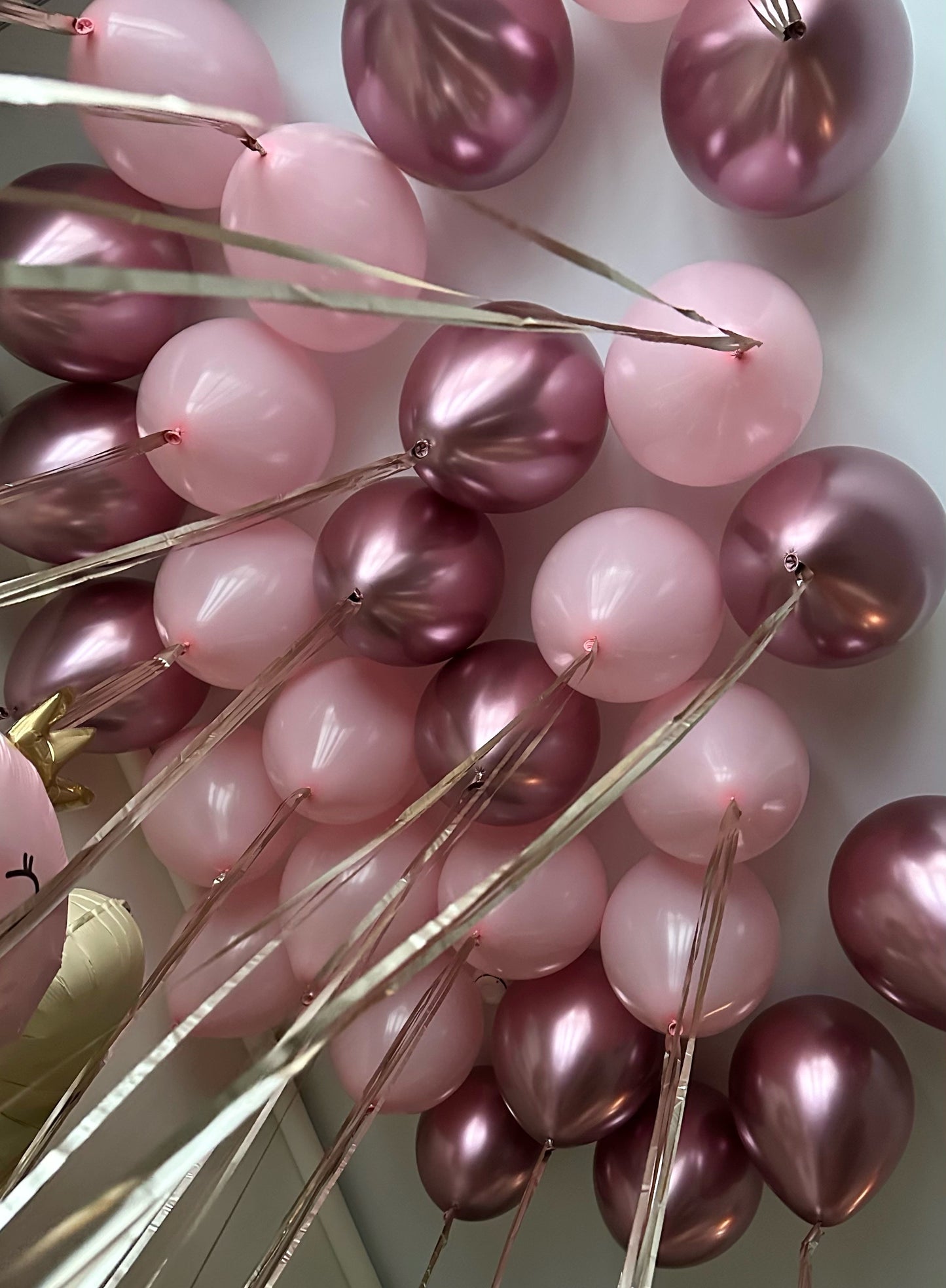 Close-up of pink metallic birthday balloons for dino princess party styling in Manhattan