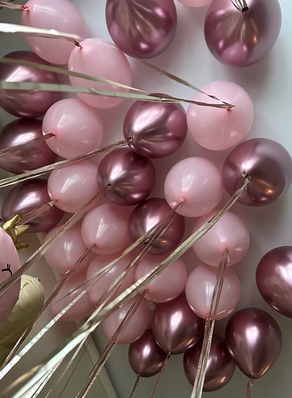 Close-up of pink metallic birthday balloons for dino princess party styling in Manhattan
