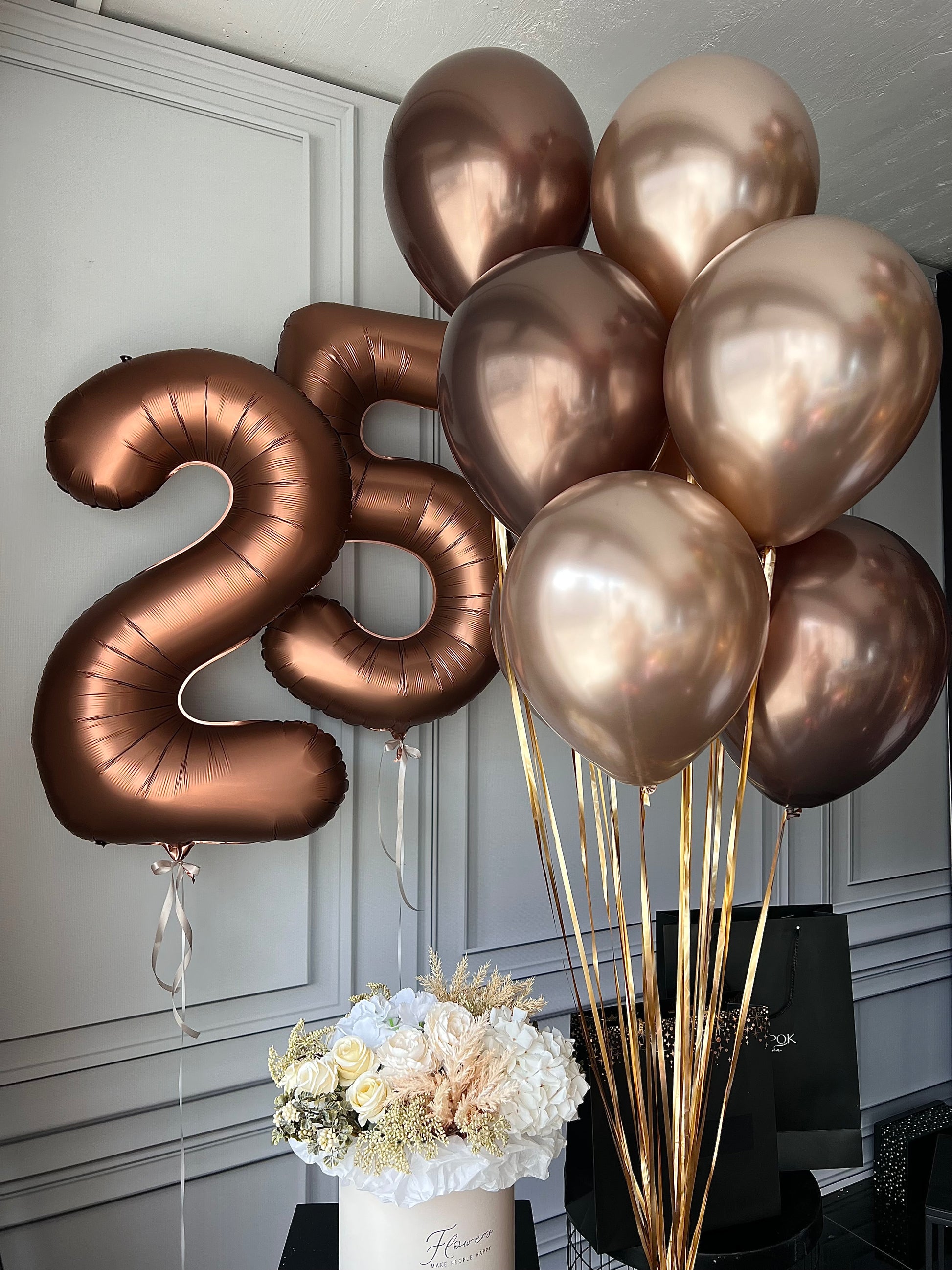 Eye catching birthday balloon set with bronze number balloons and warm neutral birthday decor in New York