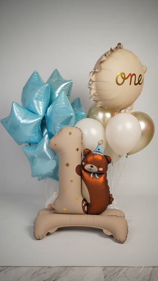 First Birthday Bear balloon set with number one balloon, teddy bear detail, and blue star balloons in New York