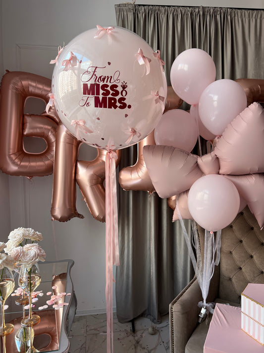 From Miss to Mrs balloon set with custom double bubble balloon, BRIDE letters, pink balloons, and bow balloon in New York