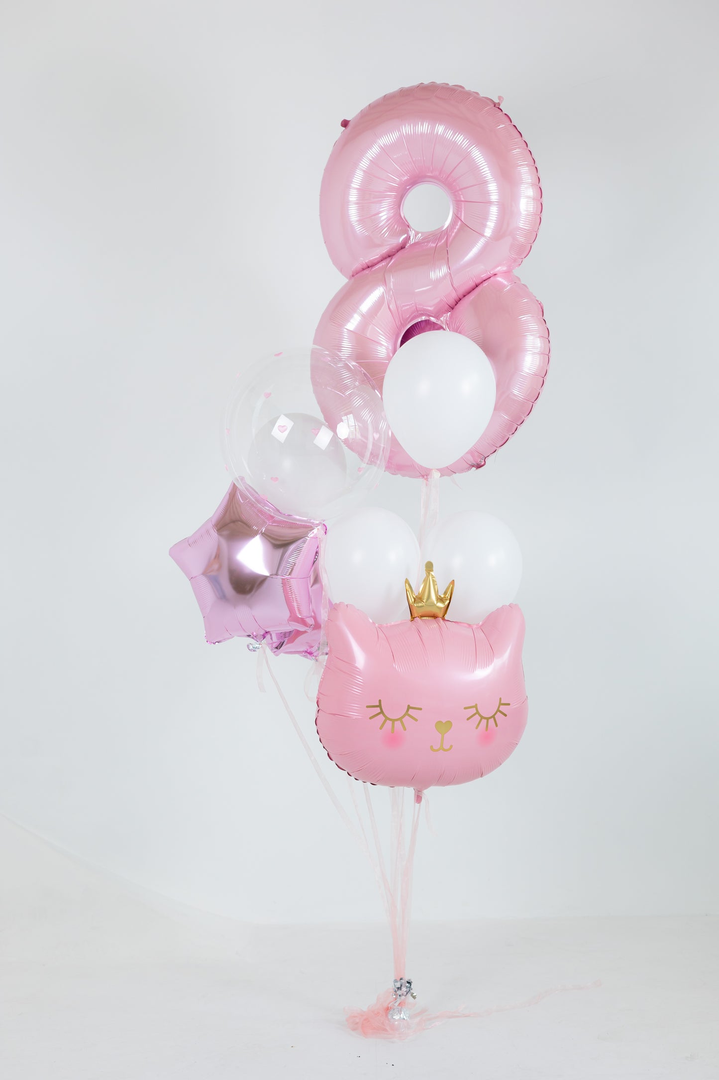 Girls birthday balloon decor with pink number balloon and cat foil balloon in Brooklyn