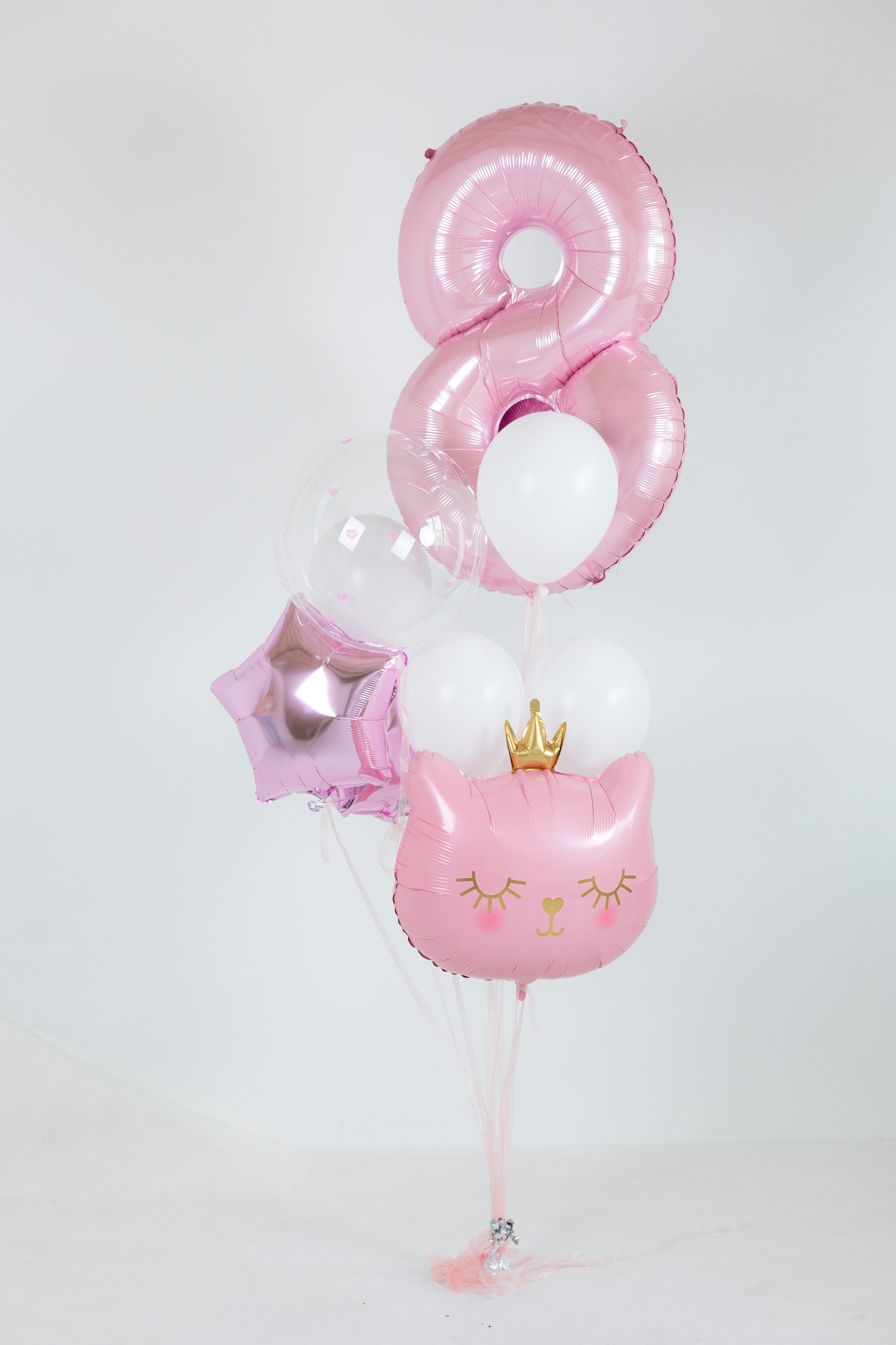 Girls birthday balloon decor with pink number balloon and cat foil balloon in Brooklyn