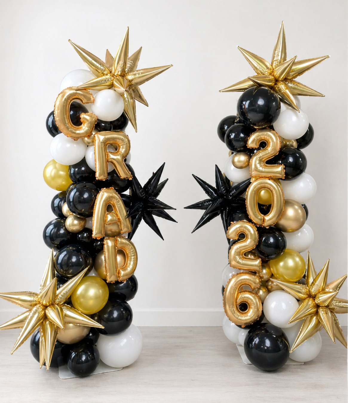 Graduation Balloon Columns with black gold white balloons, grad letters, and year numbers for graduation decor in Manhattan