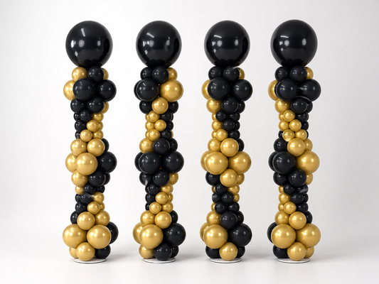 Black and gold graduation balloon columns with custom top balloons for a graduation event in Brooklyn