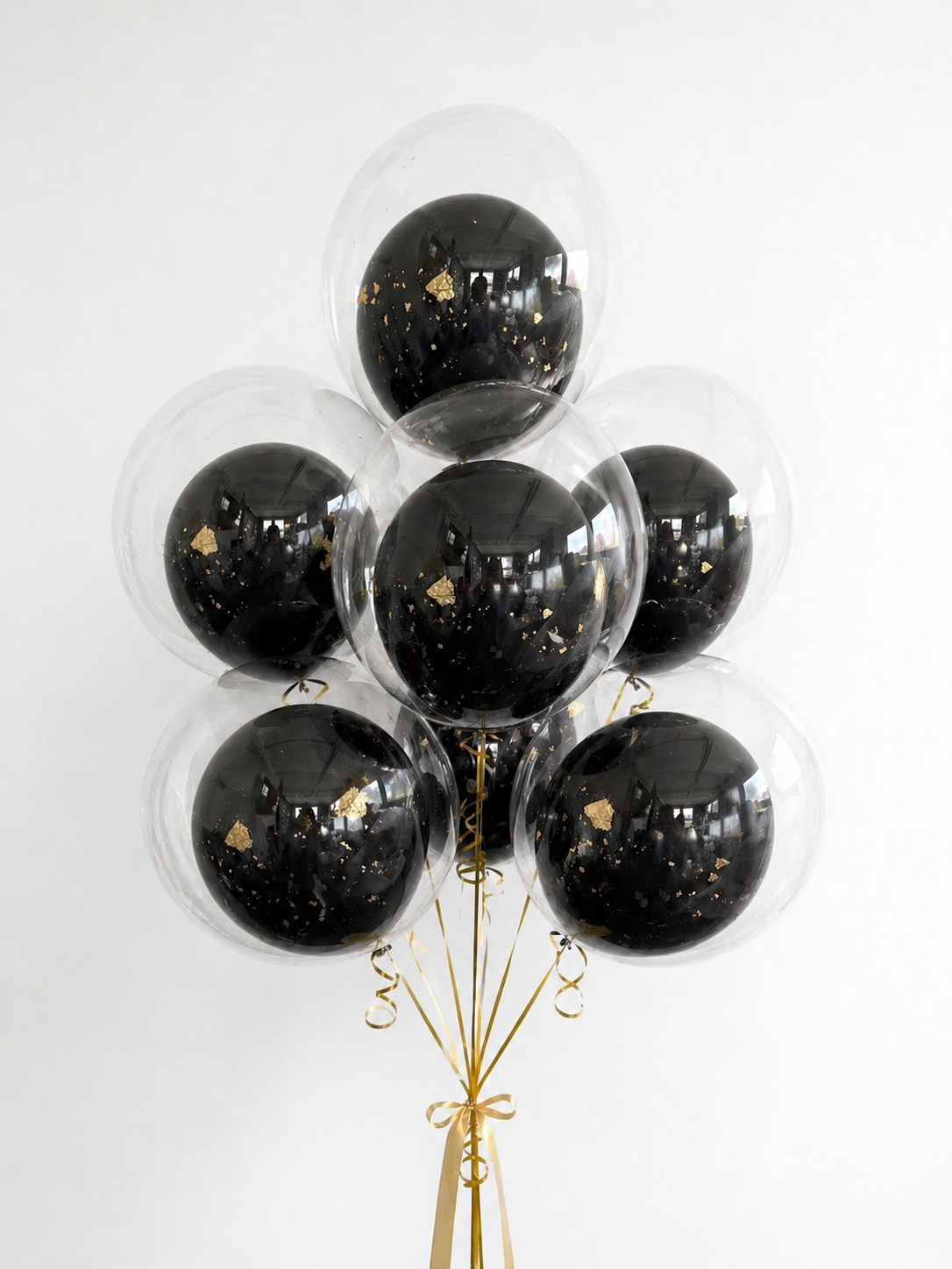 Graduation Bubble Balloon Bouquet with clear balloons, black inner balloons, and gold flakes for graduation decor in Manhattan