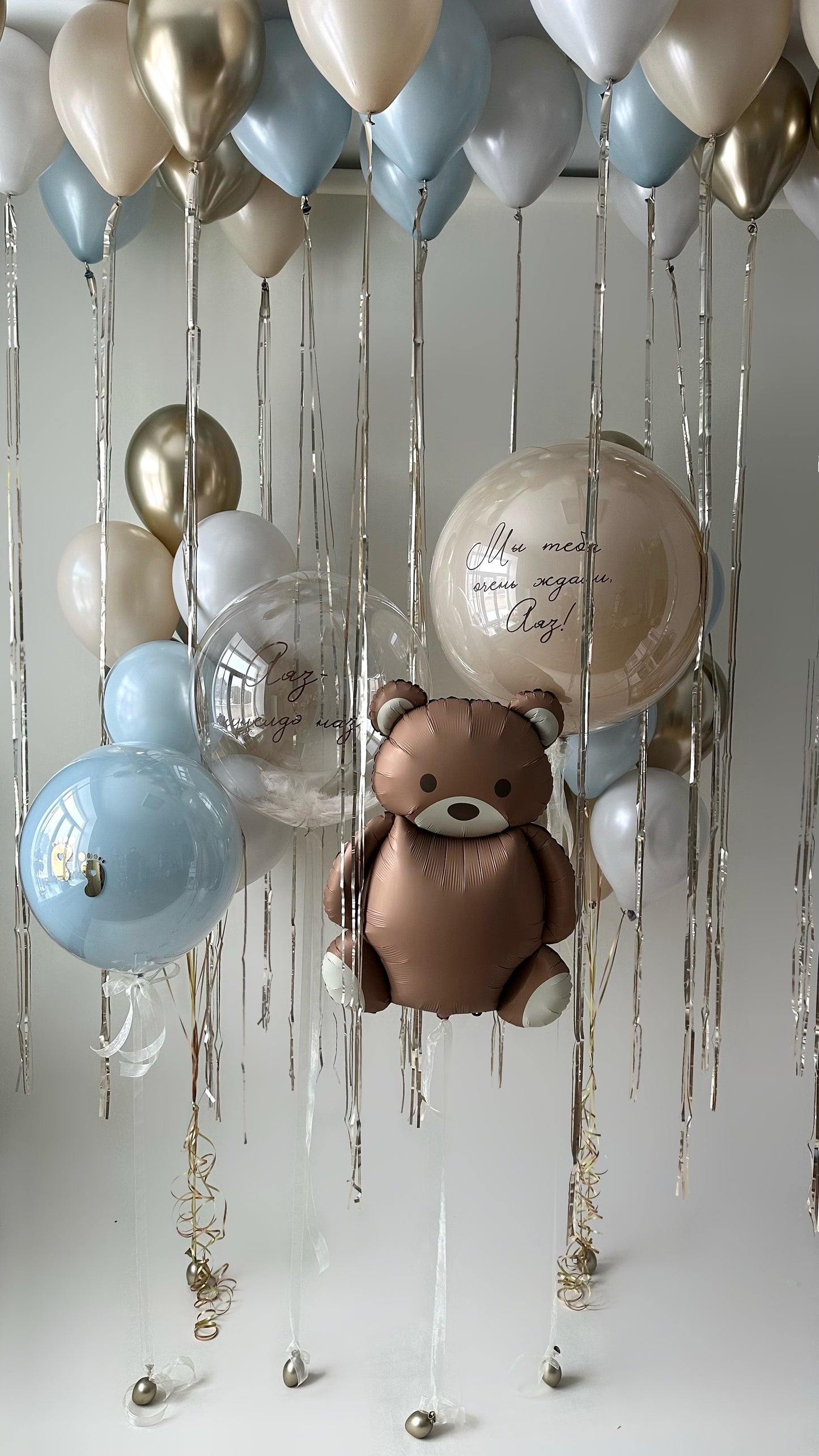 Baby welcome balloon installation with teddy bear balloon, custom sign bubble balloons, and ceiling decor in New York