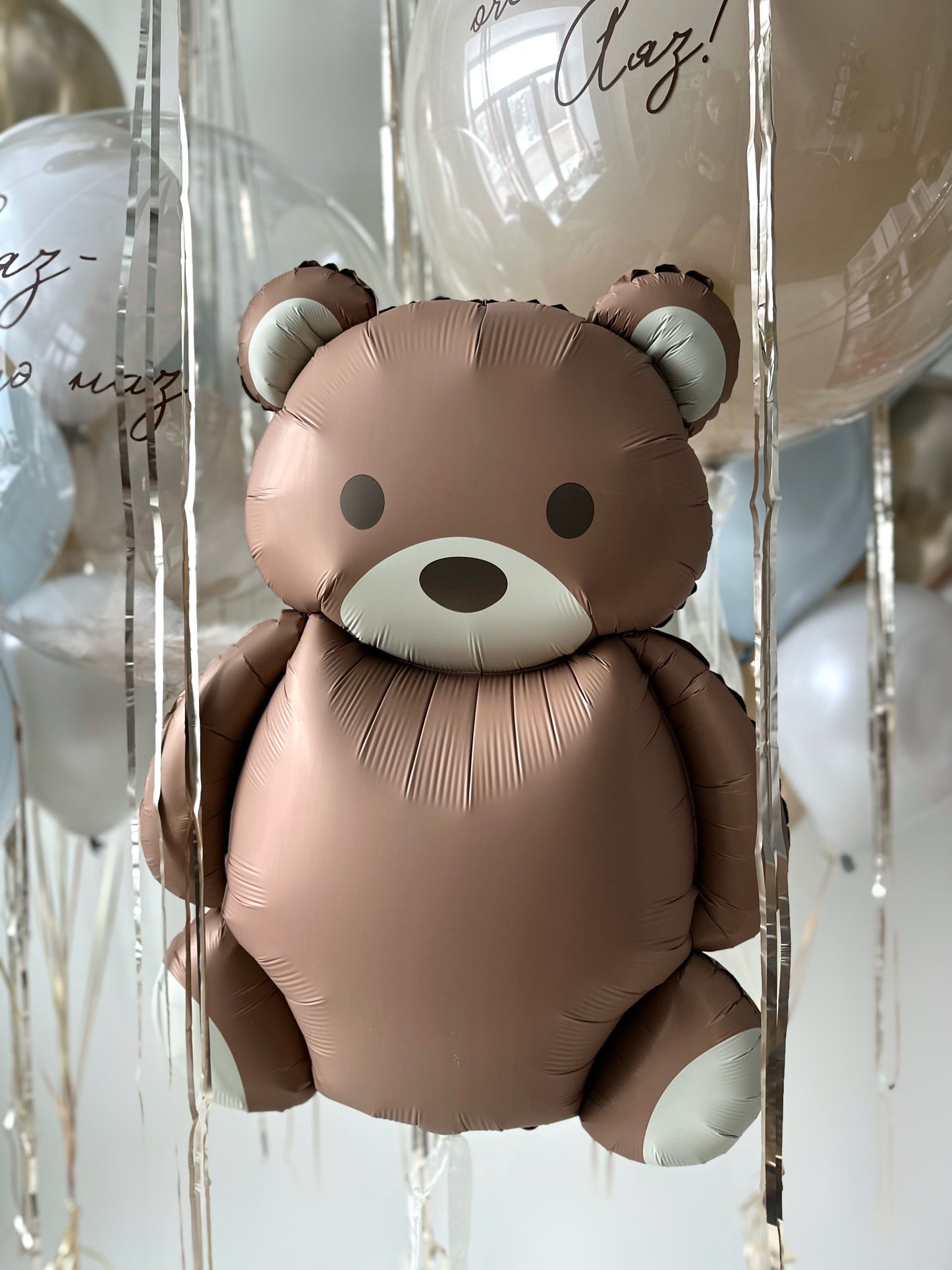 Close-up of teddy bear balloon with layered luxury baby welcome decor in Brooklyn
