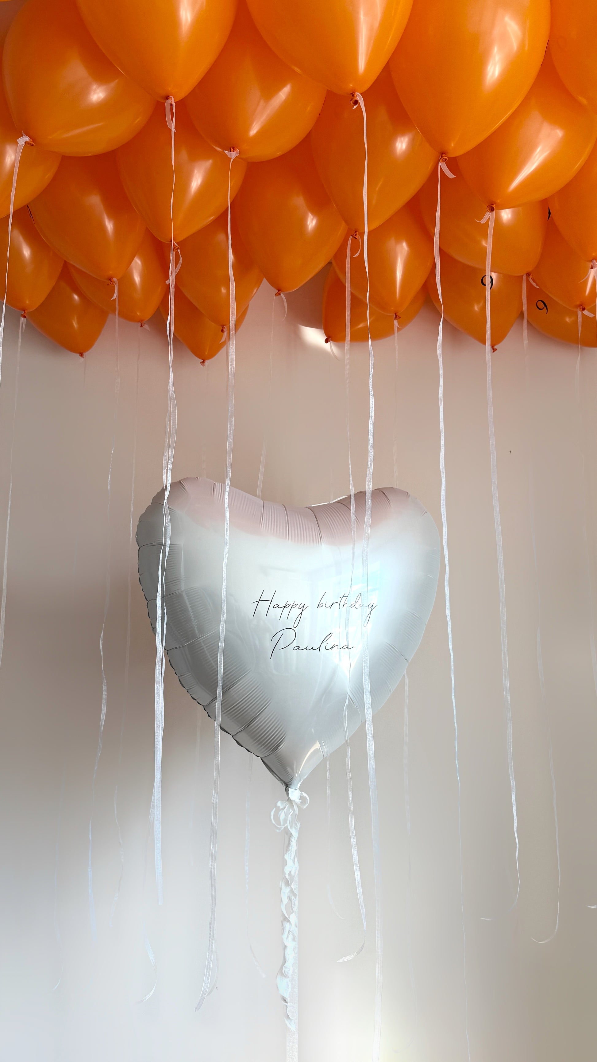 Juicy birthday balloon set with custom heart balloon and orange ceiling balloons for celebration decor in New York