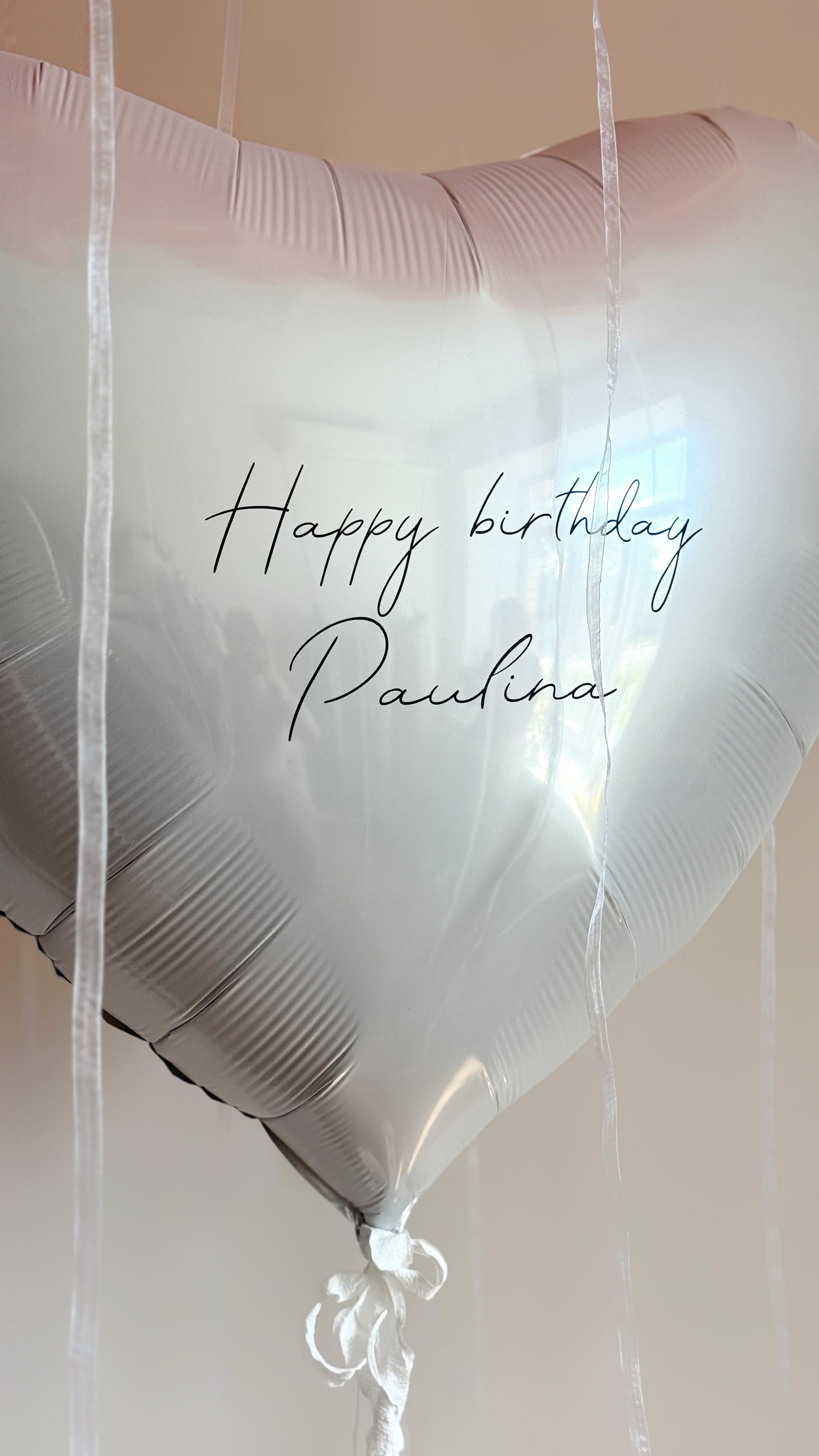 Close-up of personalized heart balloon with custom sign for birthday decor in Brooklyn