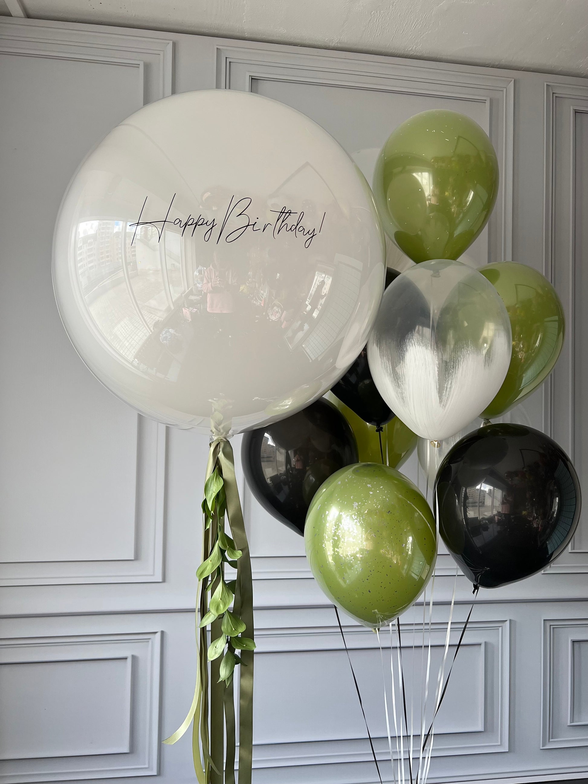 Jungle vibes balloon set with custom sign bubble balloon and green black balloons for celebration decor in New York